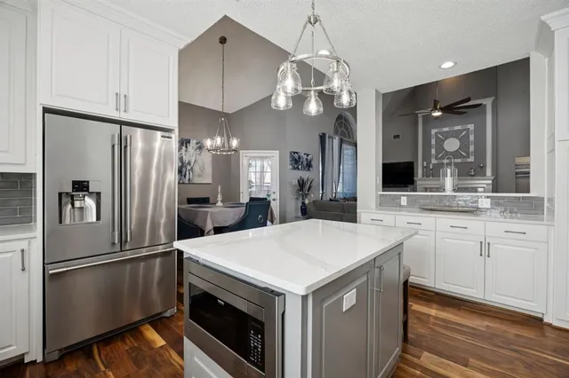 a very nice looking dining room with a table chairs and chandelier