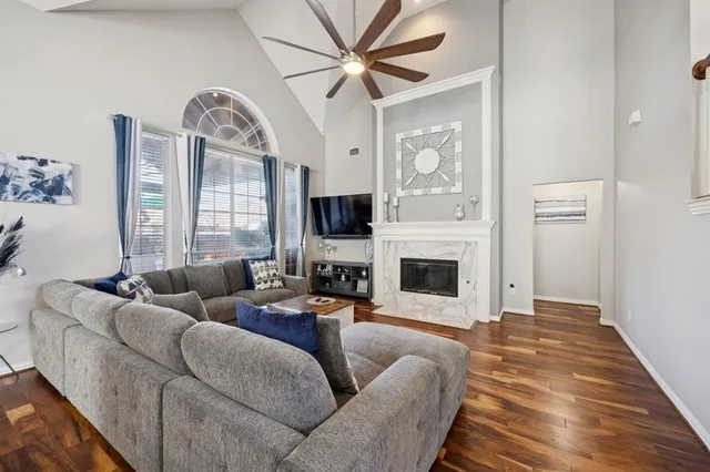 a living room with furniture a fireplace and a large window
