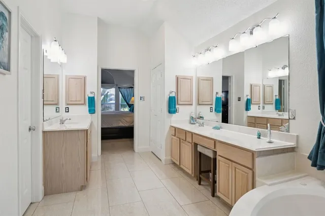 a bathroom with a tub sink and mirror