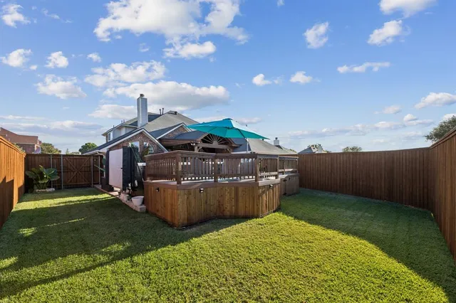 a view of a backyard with sitting area
