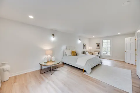 a spacious bedroom with a bed and a couch