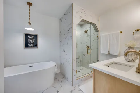 a bathroom with a sink a toilet and shower