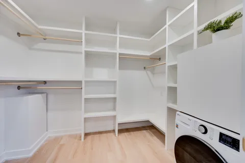 a view of walk in closet with empty racks