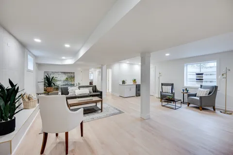 a kitchen with stainless steel appliances granite countertop white cabinets and wooden floor