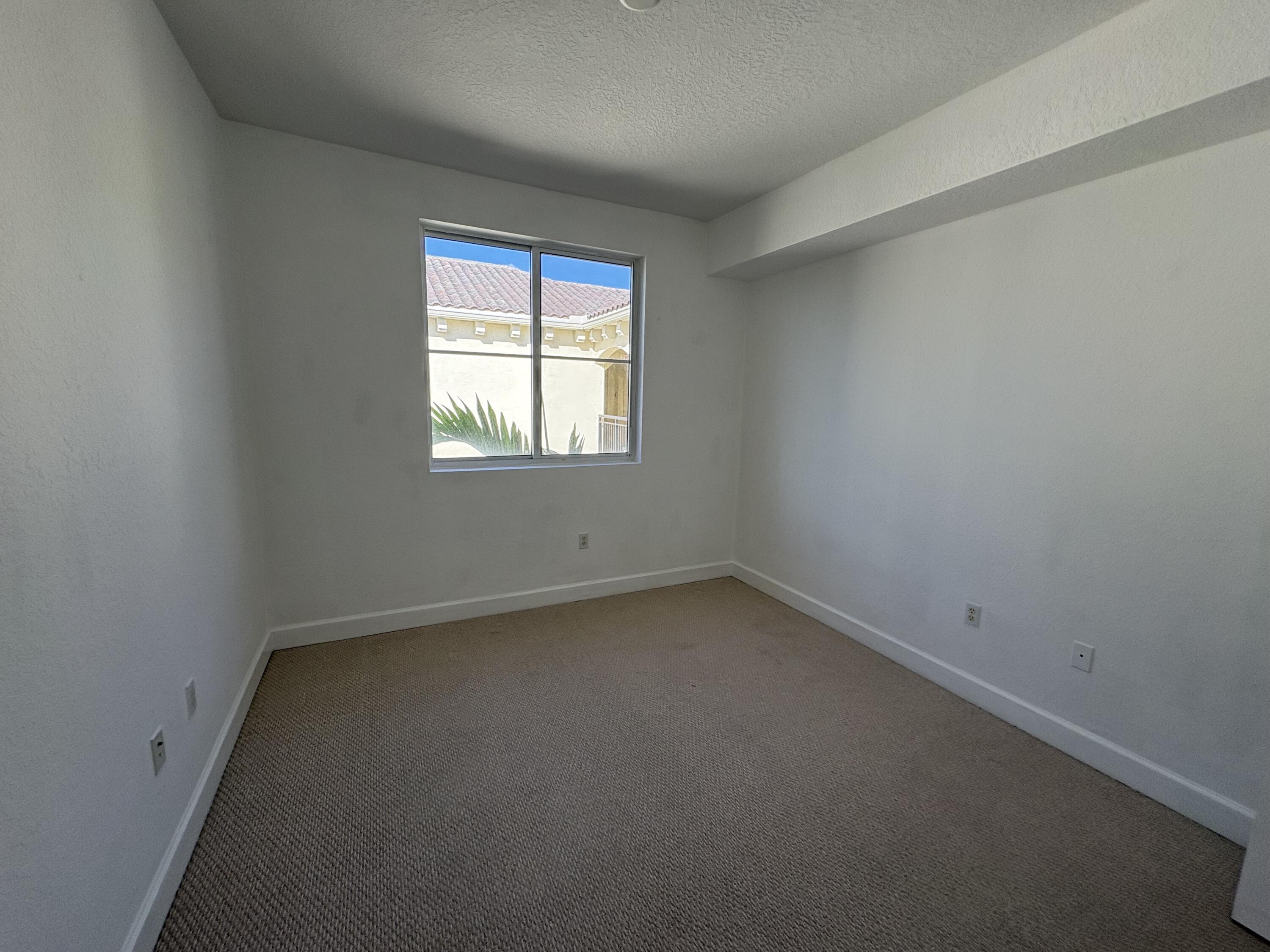 1420 Renaissance Way, Unit 420 Boynton Beach, FL 33426 - Photo 15 of 28 an empty room with a window