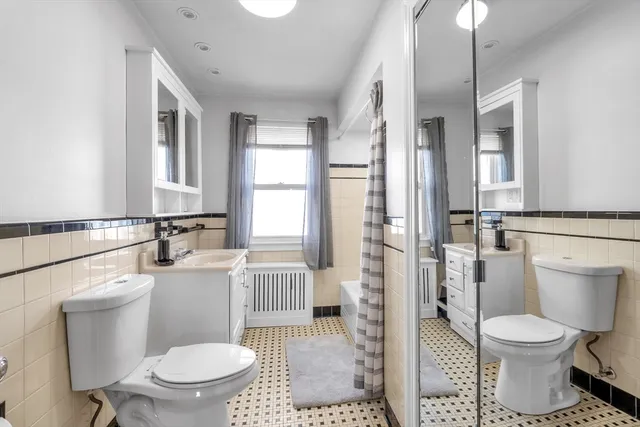 a white toilet sitting next to a bathroom sink