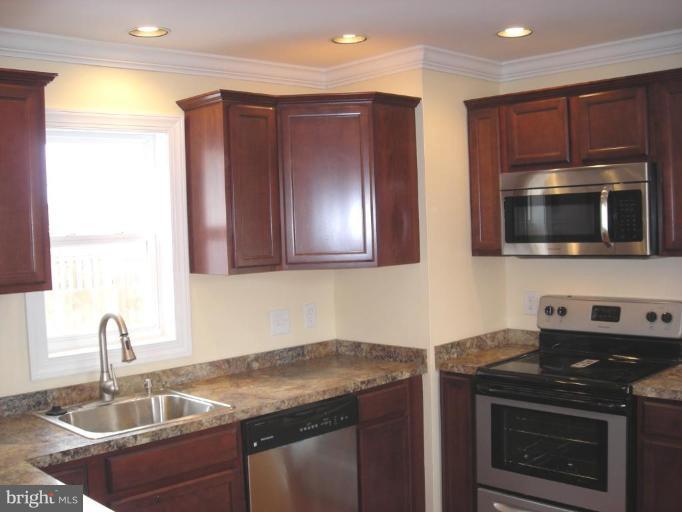 1220 Hilldale Road Rosedale, MD 21237 - Photo 1 of 19 a kitchen with stainless steel appliances granite countertop a sink stove and microwave