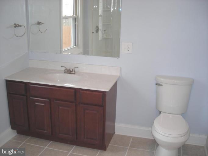 1220 Hilldale Road Rosedale, MD 21237 - Photo 15 of 19 a bathroom with a toilet sink and mirror
