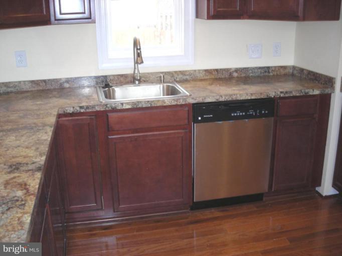 1220 Hilldale Road Rosedale, MD 21237 - Photo 4 of 19 a kitchen with granite countertop cabinets and sink