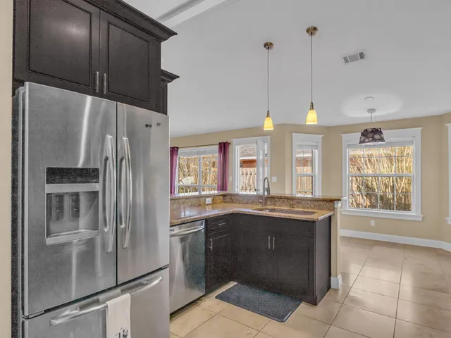 an empty room with wooden floor and a ceiling fan