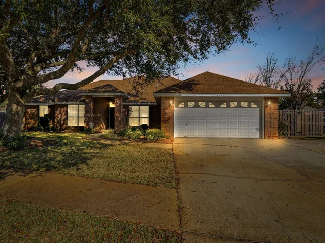 a view of an empty room with window and chandelier fan
