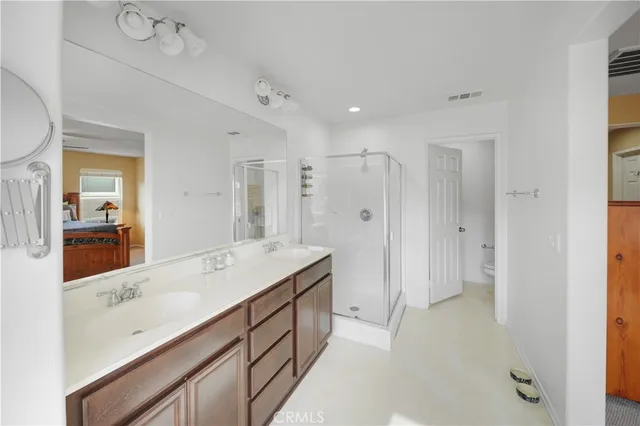 a spacious bathroom with a shower sink and mirror