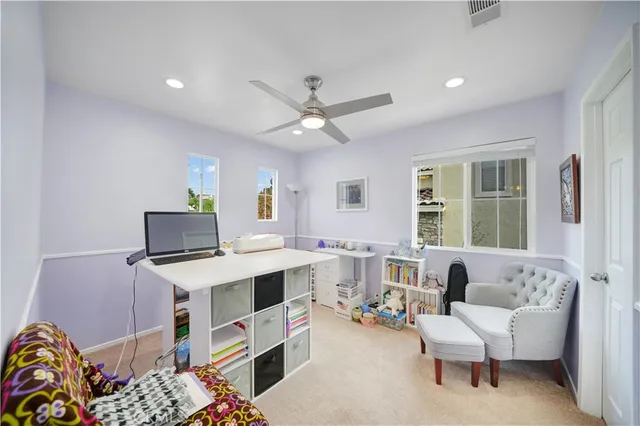 a view of a workspace with furniture and a window