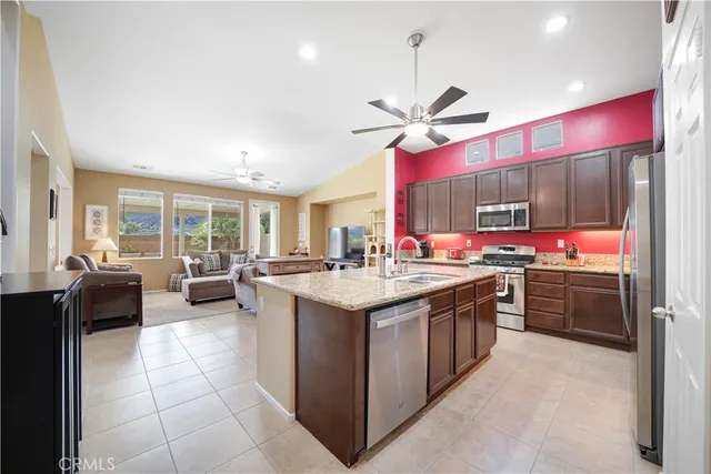 a kitchen with stainless steel appliances granite countertop a sink and cabinets