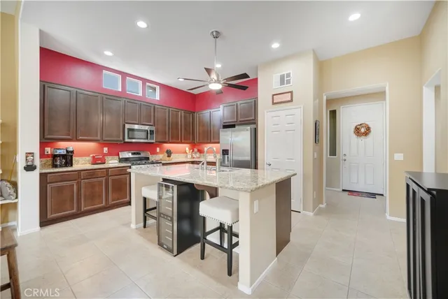 a kitchen with granite countertop a sink and cabinets