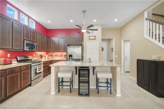 a kitchen with cabinets and chairs