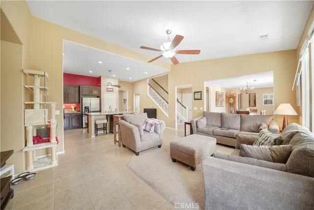 a living room with furniture and a ceiling fan