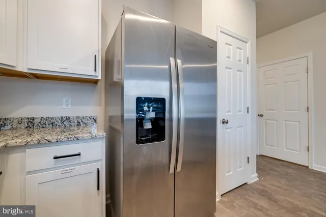 a hallway with a granite countertop sink and a granite counter top
