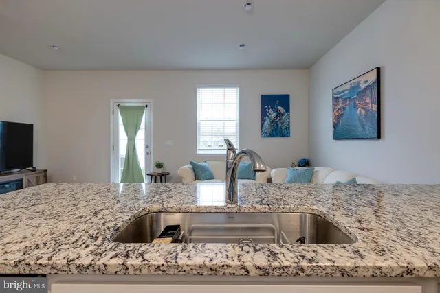 a view of a dining room with furniture and a potted plant