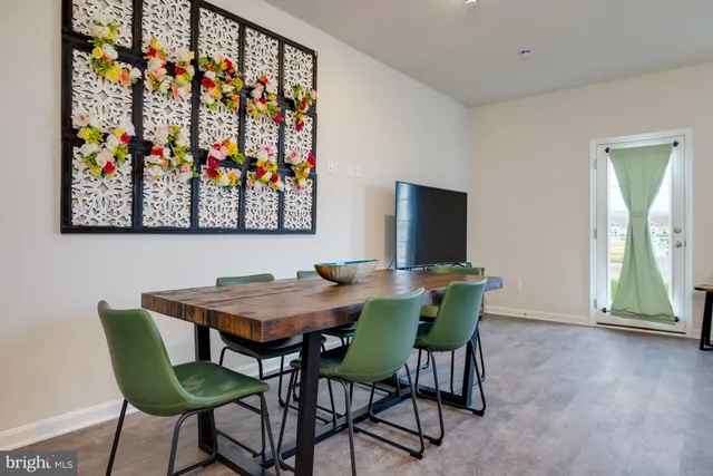 a view of a dining room with furniture and a flat screen tv