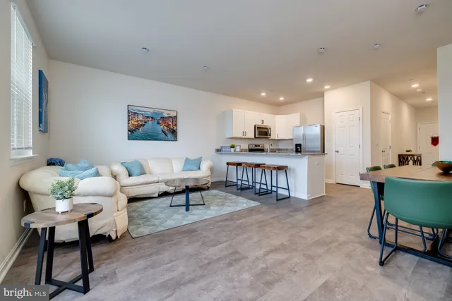 a living room with furniture a rug and a painting