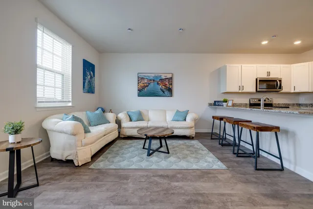 a living room with furniture a couch and a painting on the wall