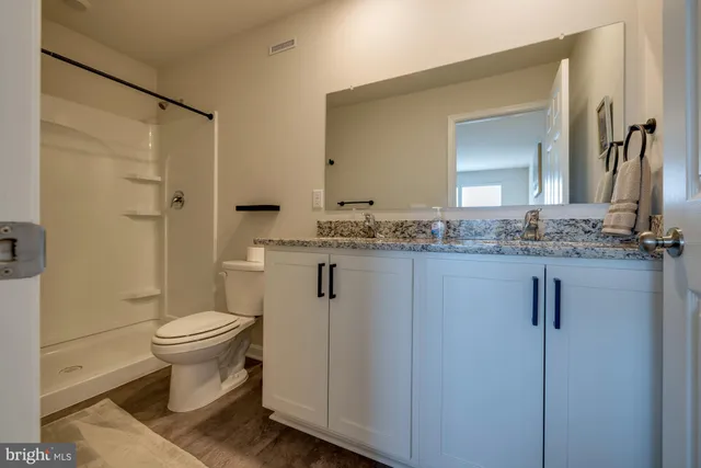 a bed room with a bed and a chair