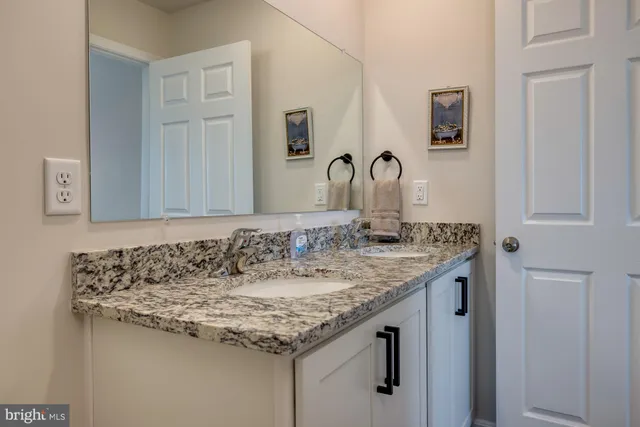 a bedroom with two beds and a television