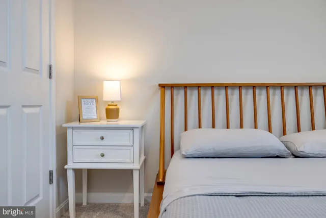 a bathroom with a granite countertop toilet sink and mirror