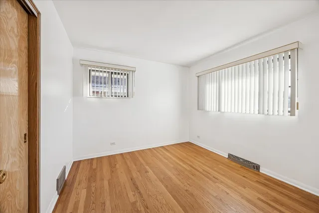 a view of a room with wooden floor and a window