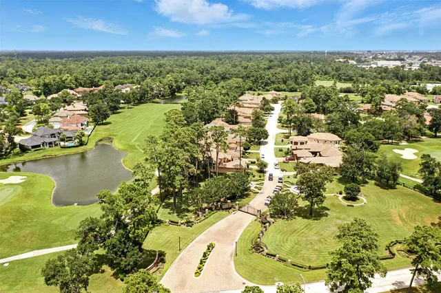 an aerial view of residential houses with outdoor space and lake view