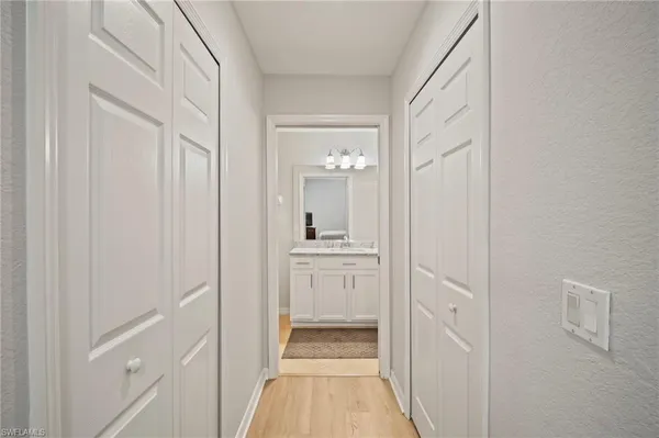 a bathroom with a granite countertop sink a mirror and a shower