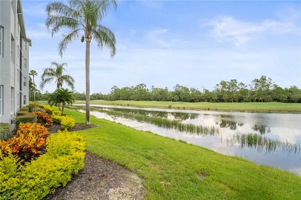 a view of a lake with a house in the background