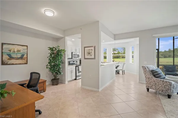 a living room with furniture ceiling fan and a flat screen tv