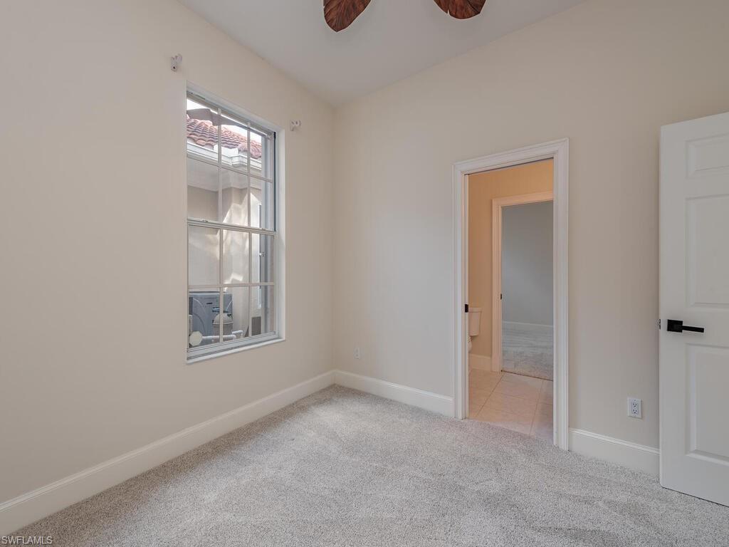 963 Fountain Run Naples, FL 34119 - Photo 10 of 12 an empty room with windows
