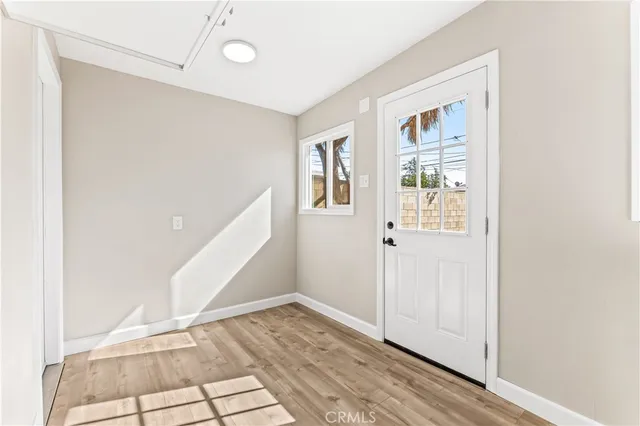 a view of an entryway with wooden floor