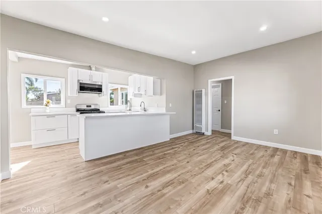 a view of a kitchen with microwave and cabinets