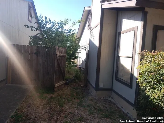 an empty room with a window and couch
