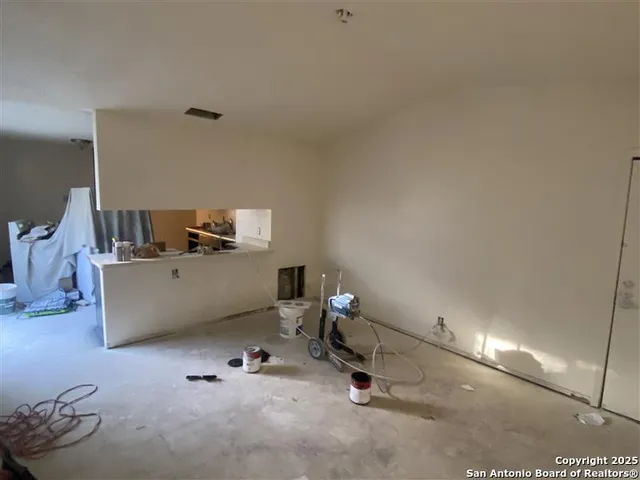 a bedroom with a bed and a refrigerator