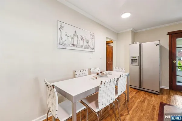 a view of a kitchen with a table and chairs