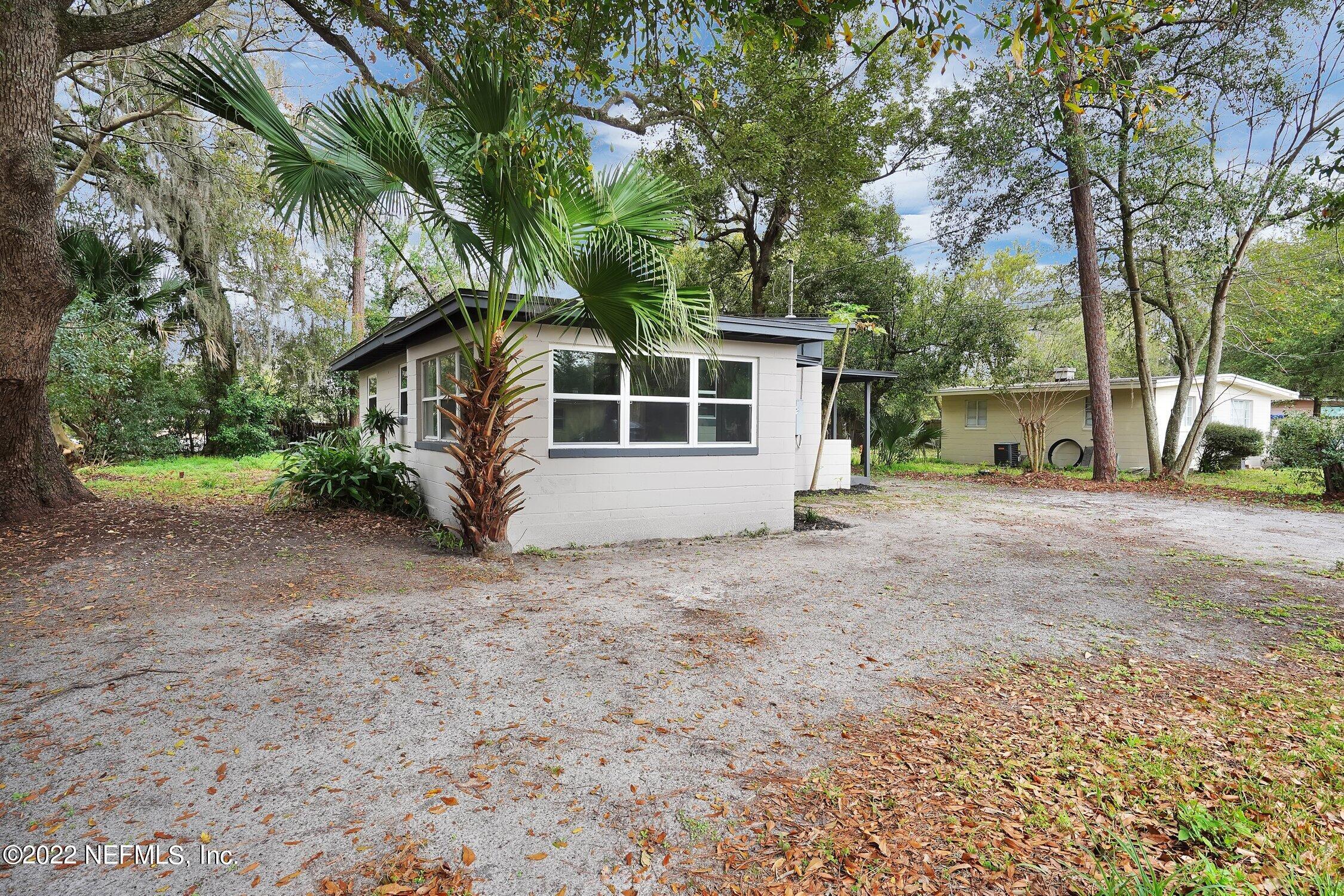 6715 Morgana Road North Jacksonville, FL 32211 - Photo 2 of 27 a view of a house with a yard and garage