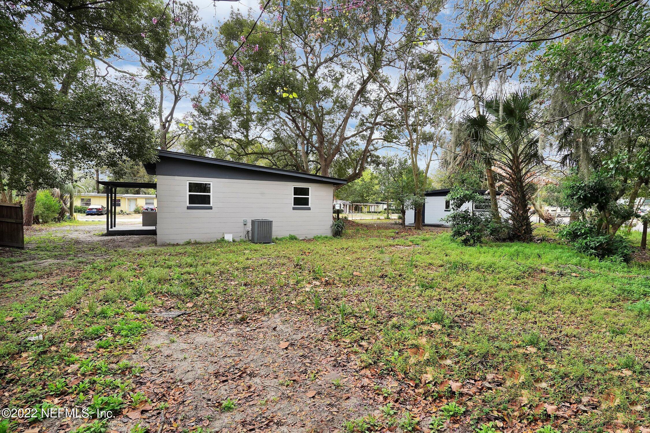 6715 Morgana Road North Jacksonville, FL 32211 - Photo 27 of 27 a view of a backyard with a garden and trees