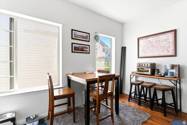 161 25th Street, Unit 6B Ogden, UT 84401 - Photo 5 of 20 Bright dining area with wood-finish flooring, white walls, and multiple windows