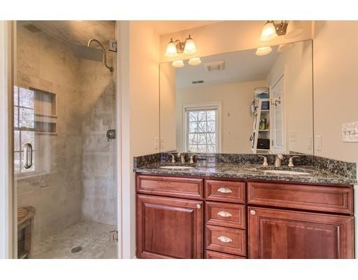 24 Paul Revere Road Needham, MA 02494 - Photo 20 of 30 a bathroom with a granite countertop sink a mirror and a shower