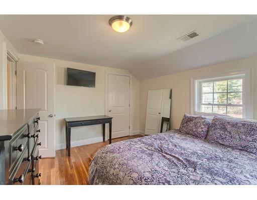 24 Paul Revere Road Needham, MA 02494 - Photo 24 of 30 a bedroom with a bed and a flat screen tv