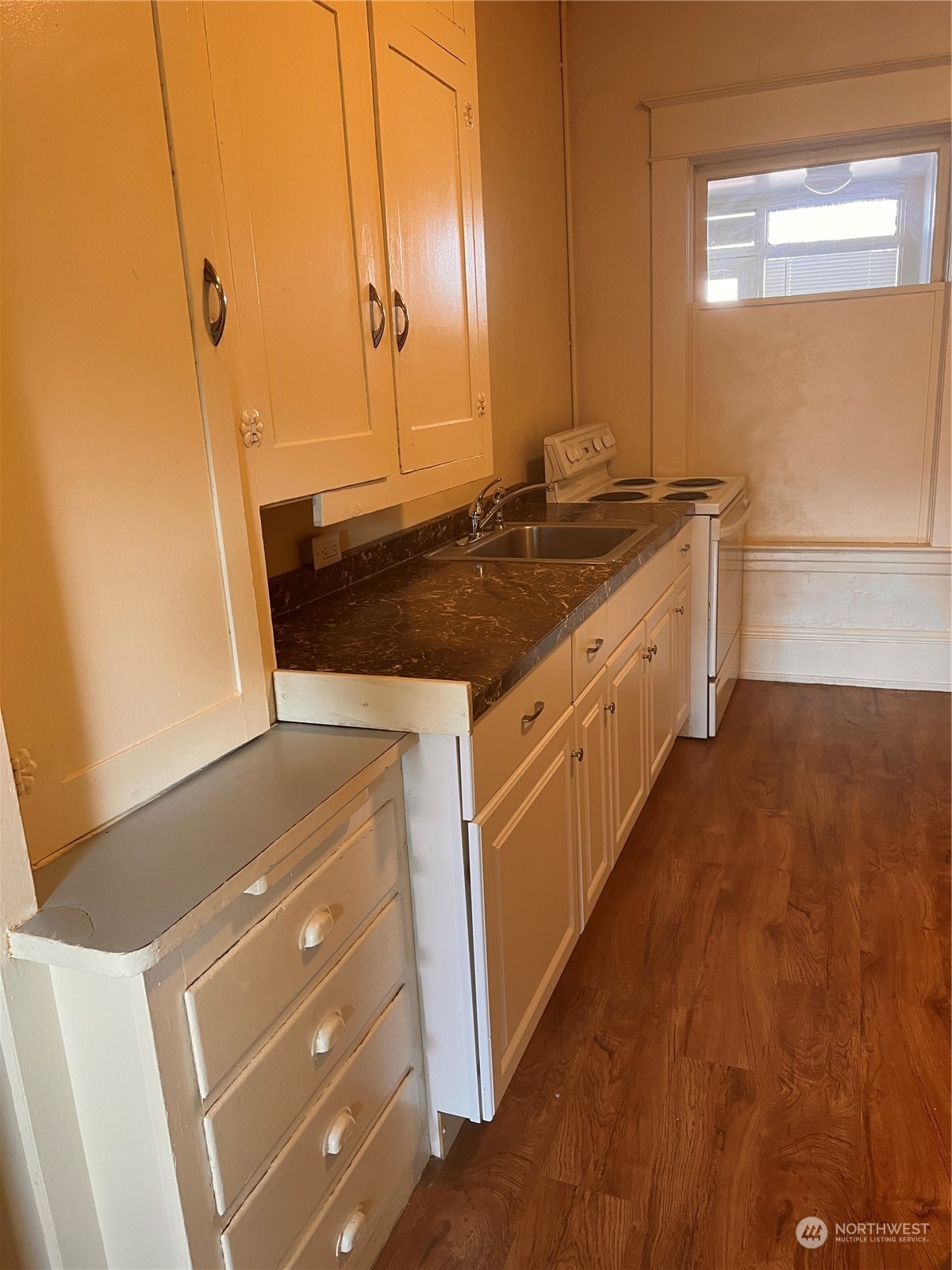 1201 Pacific Avenue Everett, WA 98201 - Photo 11 of 24 a kitchen with a sink stove and cabinets