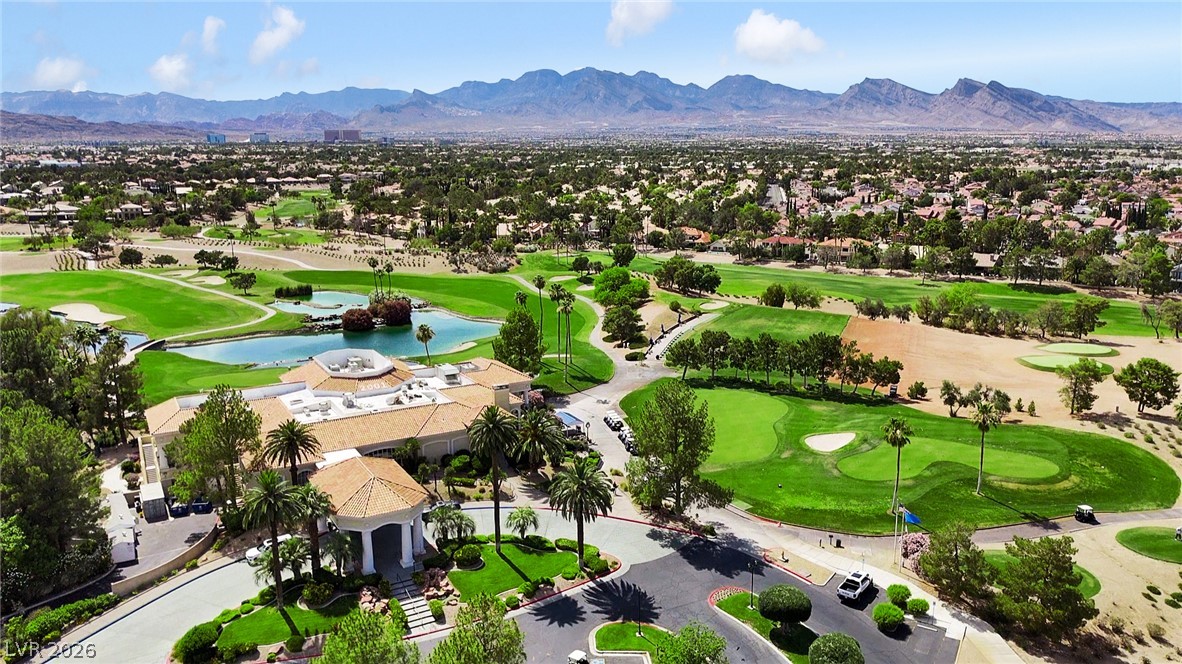 8981 Rivers Edge Drive Las Vegas, NV 89117 - Photo 68 of 69 An aerial panorama reveals a vast golf course and an elegant clubhouse nestled against distant mountains.