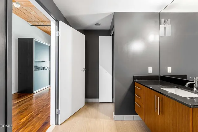 a spacious bathroom with a sink and a mirror