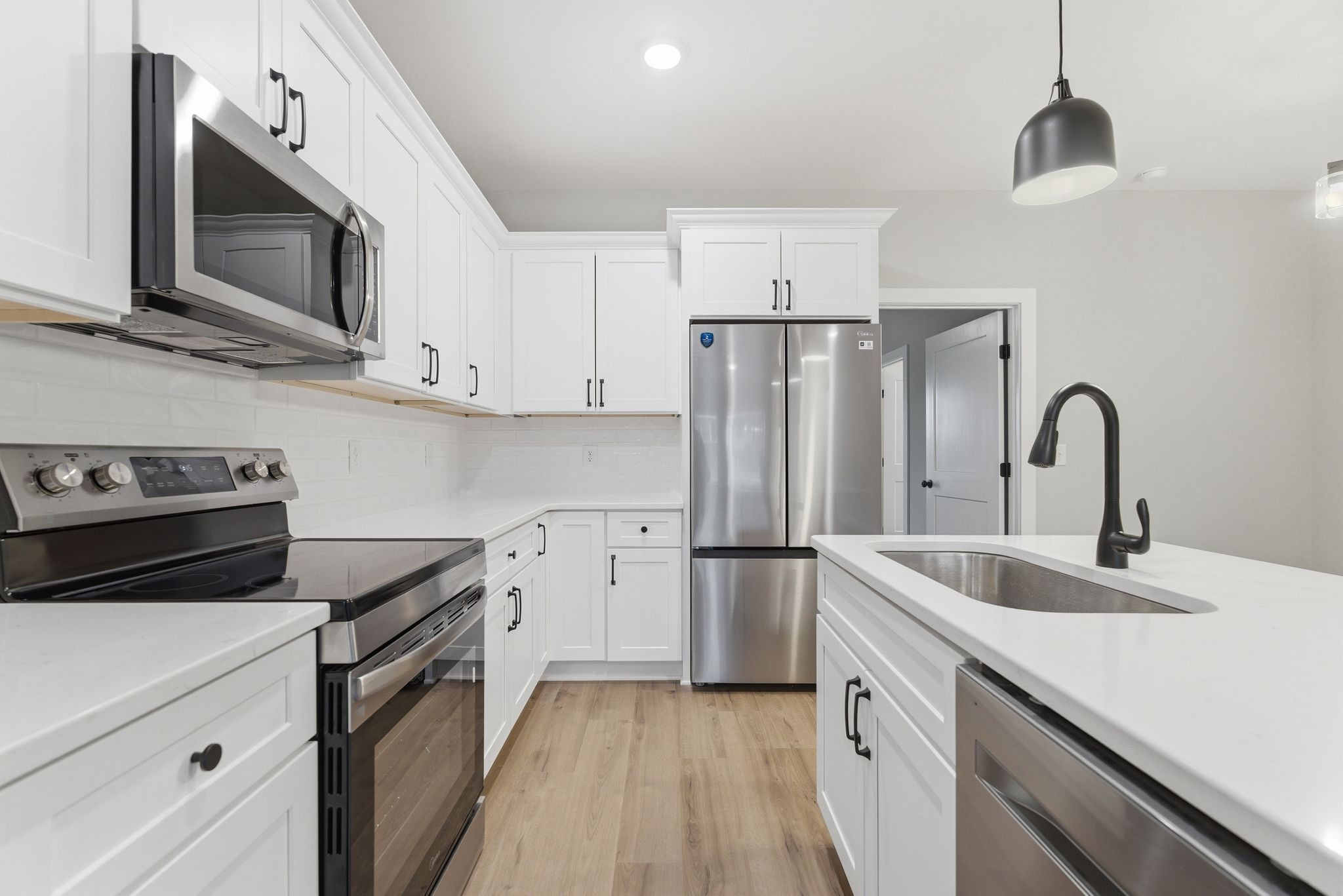 263 West Spring Street Smithville, TN 37166 - Photo 11 of 23 a kitchen with stainless steel appliances a sink cabinets and a wooden floor