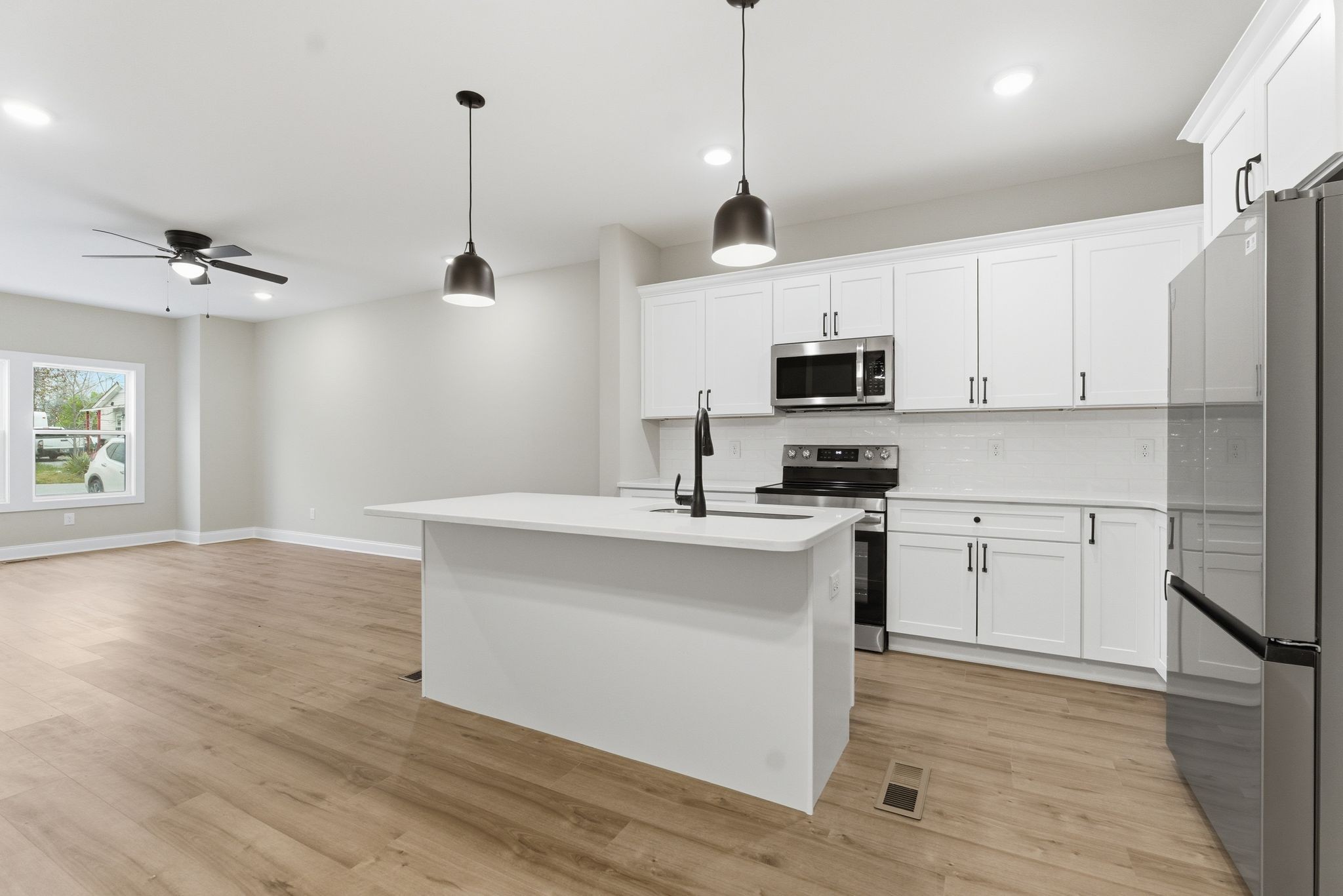 263 West Spring Street Smithville, TN 37166 - Photo 12 of 23 a kitchen with stainless steel appliances granite countertop a stove a sink and a refrigerator